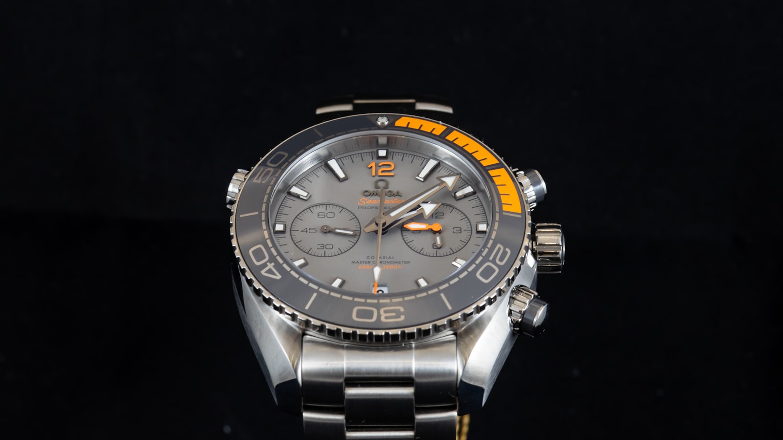 Slim dress watch on a leather strap against a dark cuff