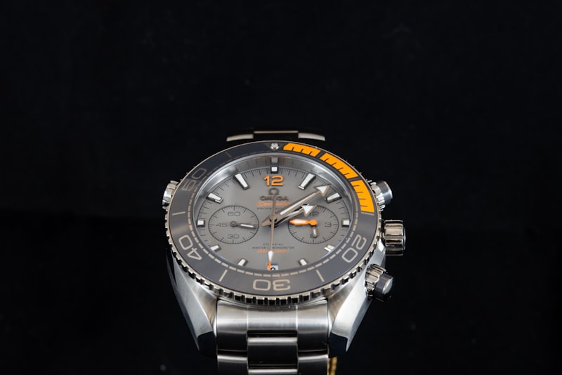 Slim dress watch on a leather strap against a dark cuff