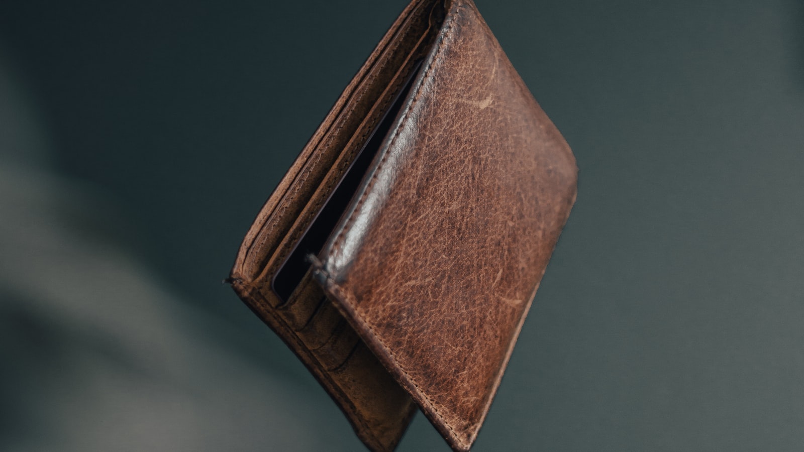 Slim leather wallet beside a traditional bifold